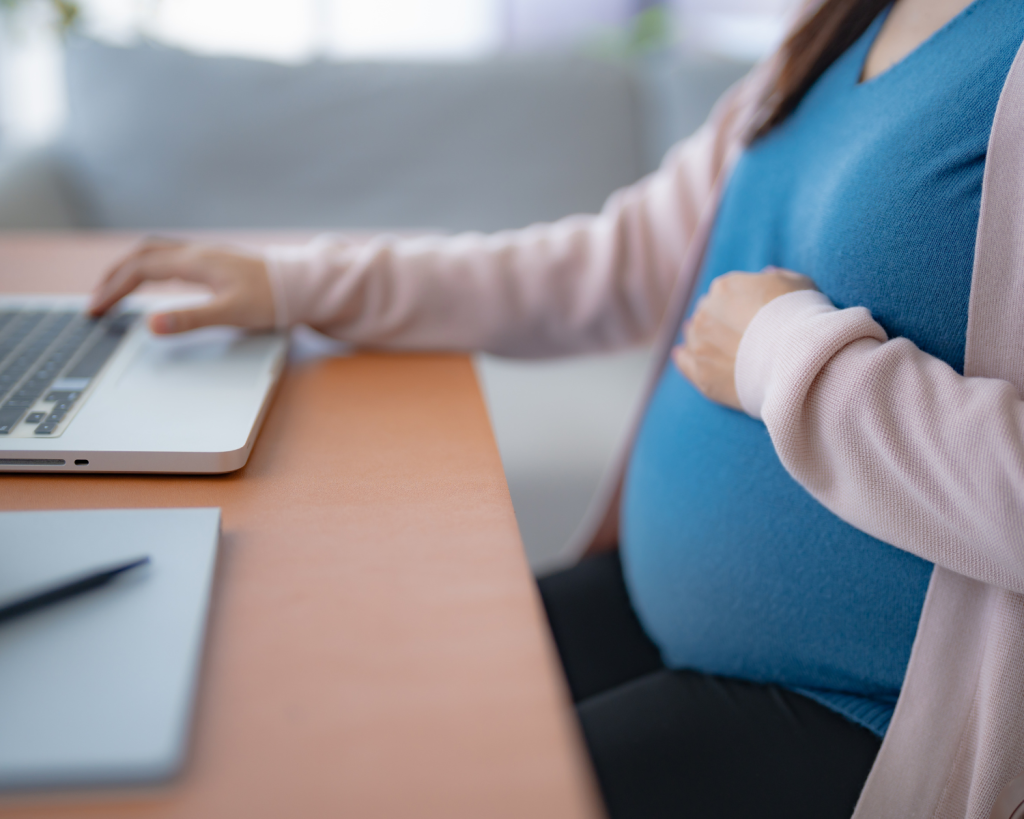 Pregnant woman working on laptop